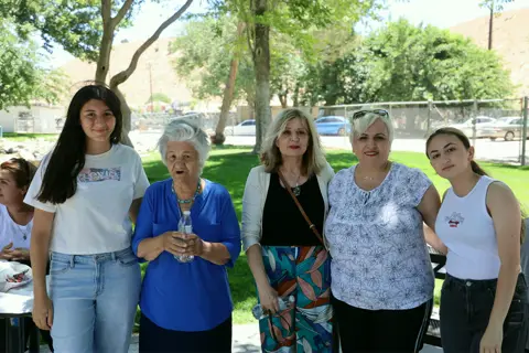 Women and girls of the parish posing together on the picnic lawn
