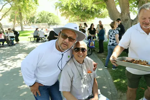 Two friends in sun hats hamming it up for the camera
